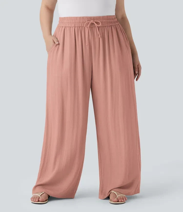 Framifrån av dambyxor med vida ben och hög midja i rosa ton