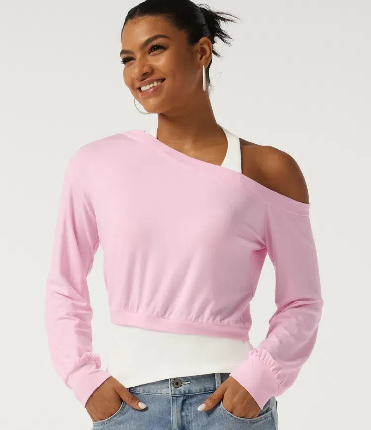 Kvinna i rosa och vit asymmetrisk färgblock sweatshirt framifrån