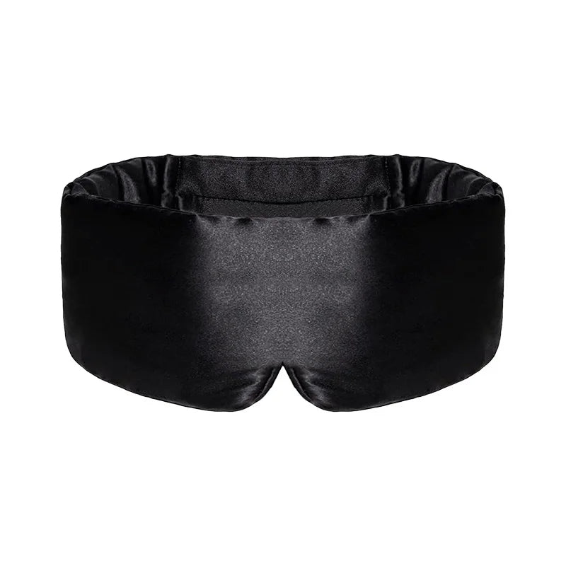 Svart sovmask med mjuk design mot ljusa bakgrunder
