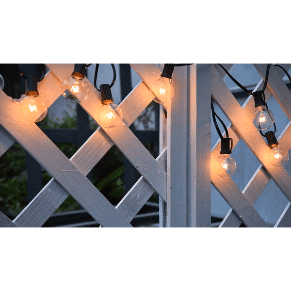 FairyFlicker LED ljusslinga uppsatt på vit trävägg med varmt sken