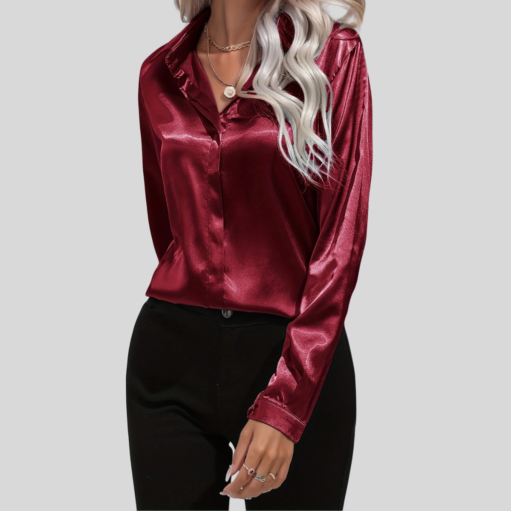 Elegant damblus med lång ärm och dekorativa knappar, framifrån
