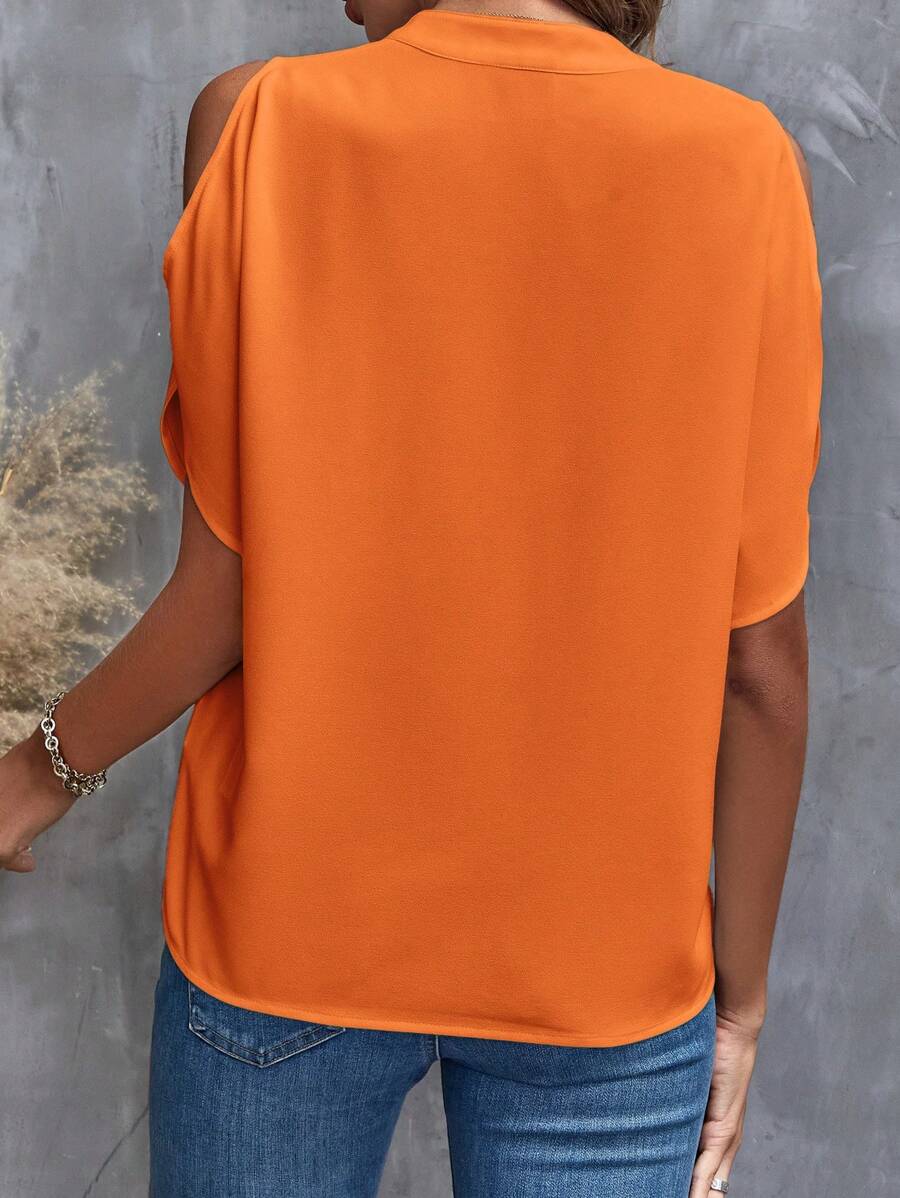 Elegant kortärmad blus för kvinnor i en stark orange nyans
