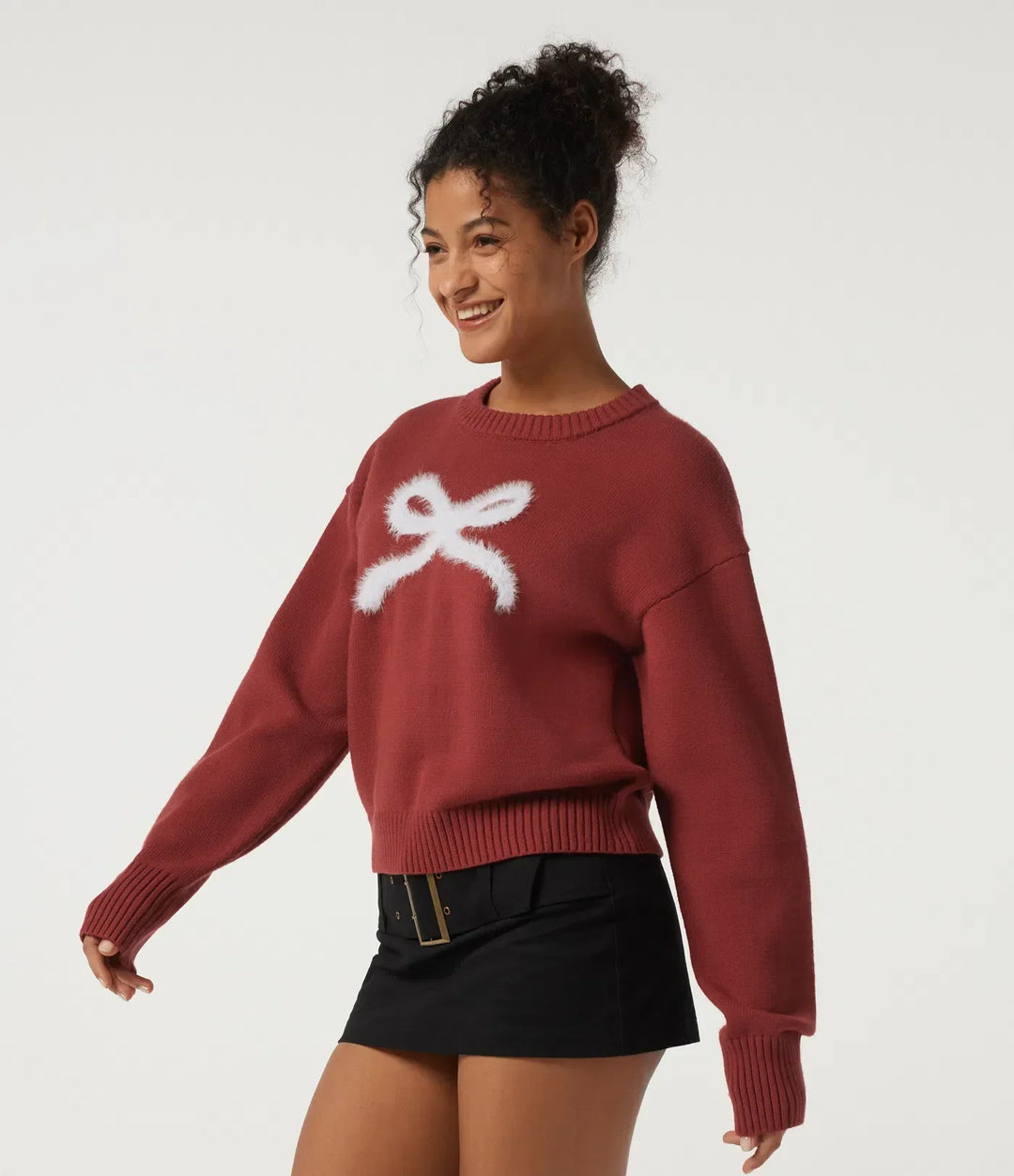 Profilbild på modell i röd damtröja med rosettdetalj