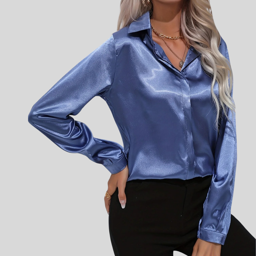Elegant blå damblus med lång ärm och knappar framtill