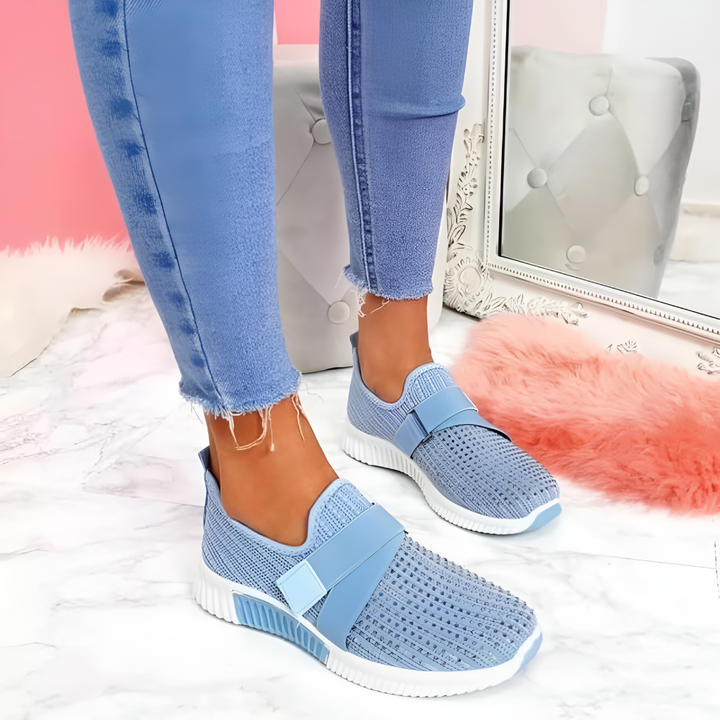 Blå stickade slip-on träningsskor för dam med elastiskt band på modell