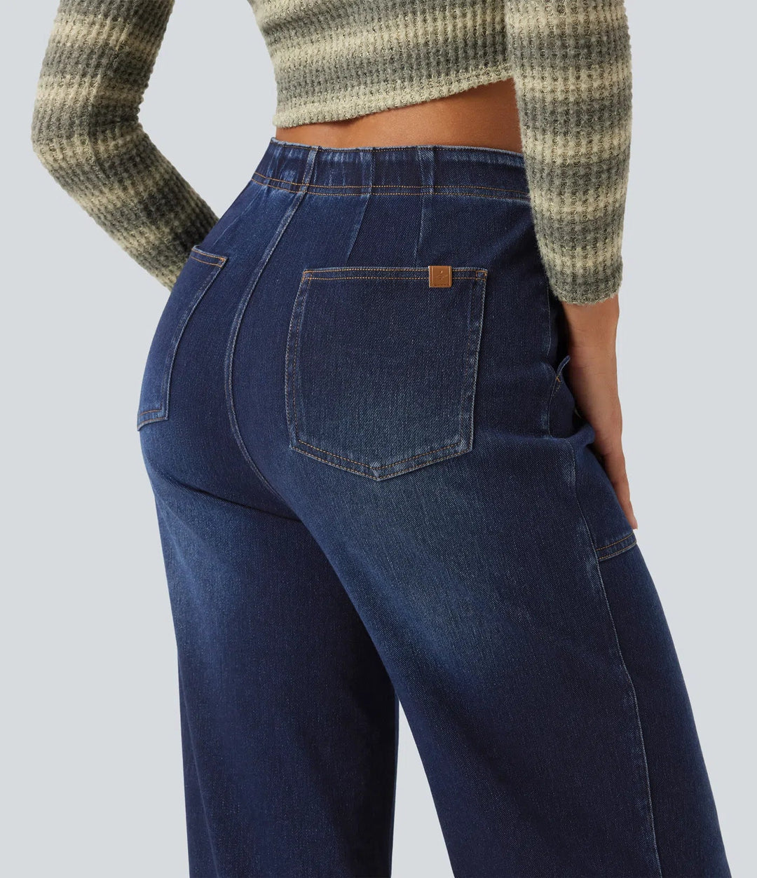 Detaljbild på fickor och sömmar på vida damjeans