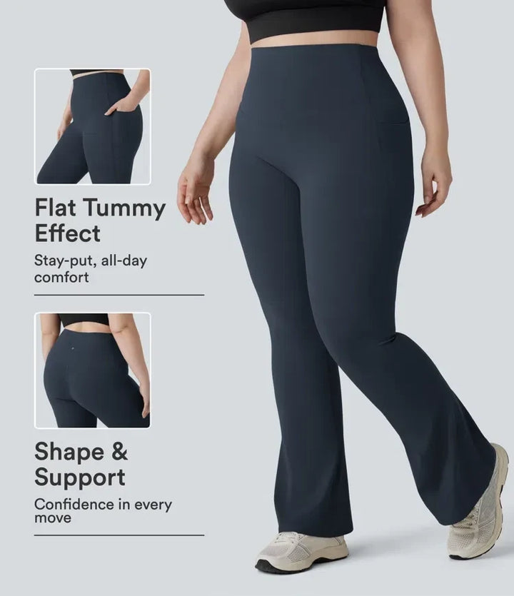 Kvinna i mörka högmidjade yoga bootcut leggings med fickor