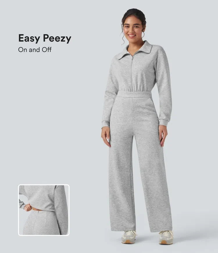 Framifrån av kvinna i grå långärmad jumpsuit med dragkedja och krage