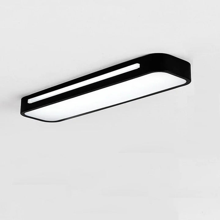 Minimalistisk taklampa som sprider behagligt ljus i vardagsrummet