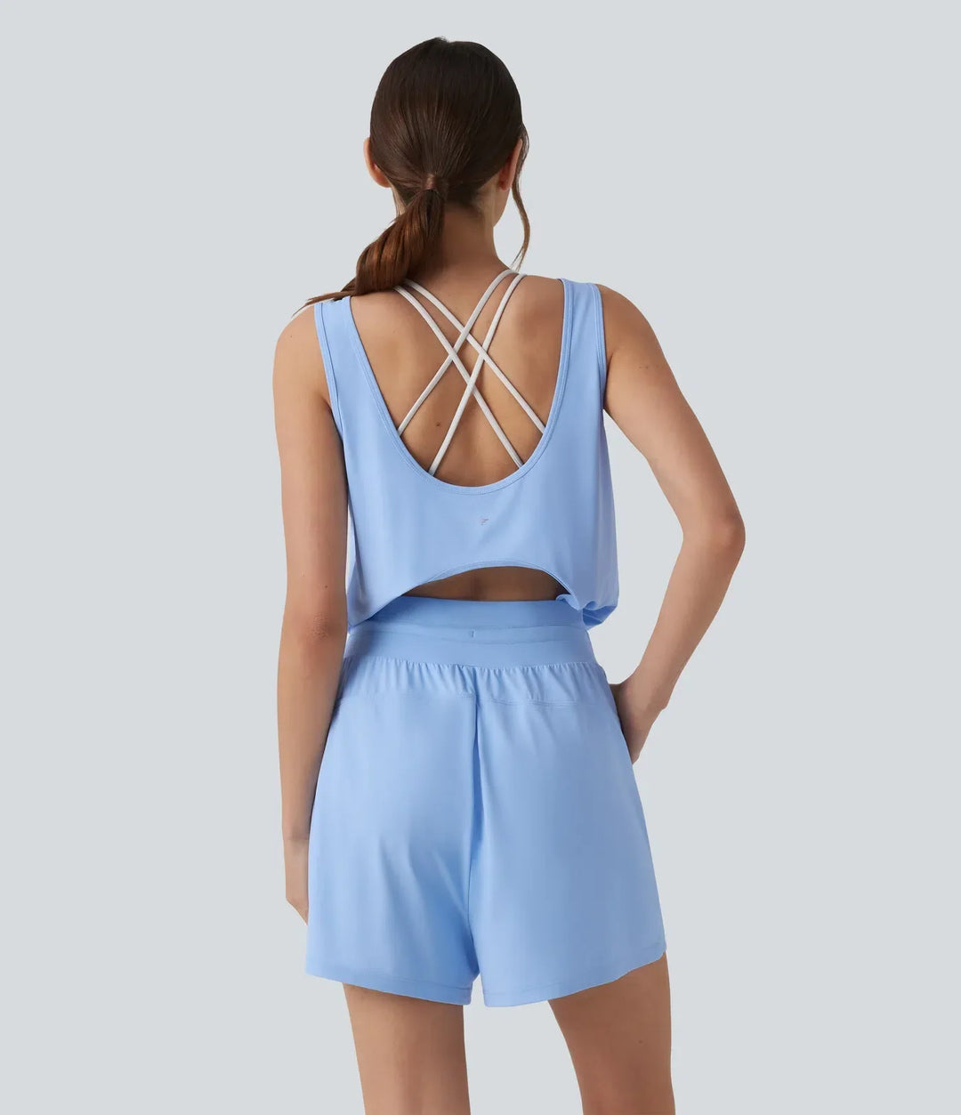 Snygg träningskläder playsuit för dam i blått tyg med praktisk dragsko