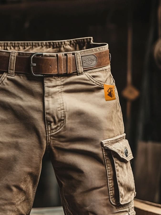 Närbild på khakifärgade cargoshorts med sidoficka och detaljer