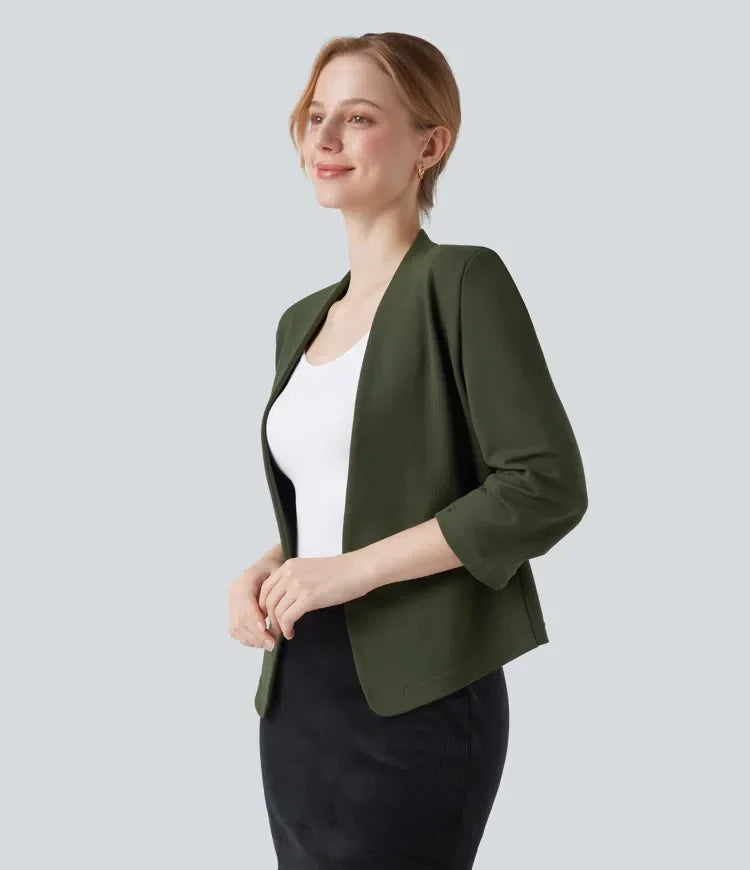 Profilbild av kvinna i grön stilren arbetskavaj