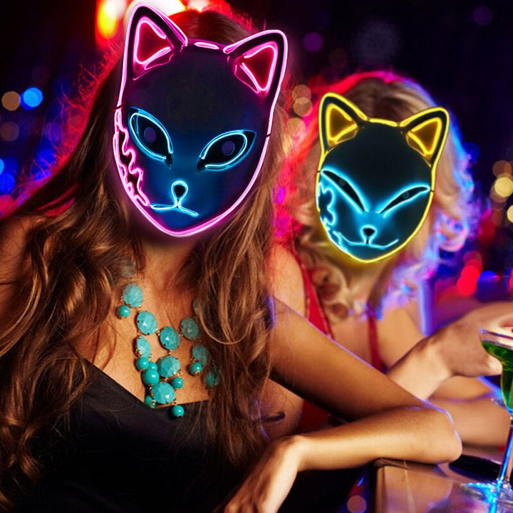 Två personer i festmiljö som bär lysande LED-masker i olika färger