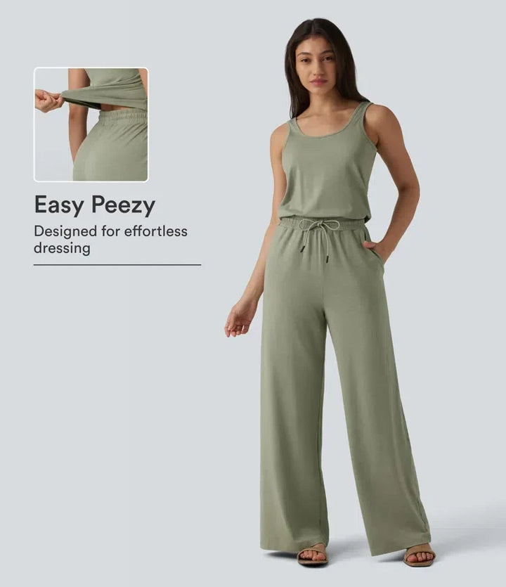 Dam i melerad grön ärmlös jumpsuit med dragsko i midjan och fickor