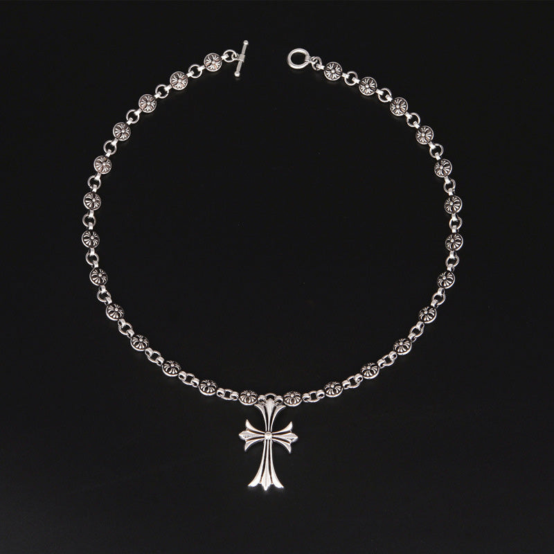 Gotiskt korshänge halsband med silverfinish mot svart bakgrund