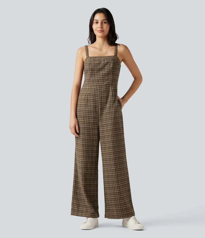 Kvinna framifrån i en stilren rutig jumpsuit med axelband och praktiska fickor