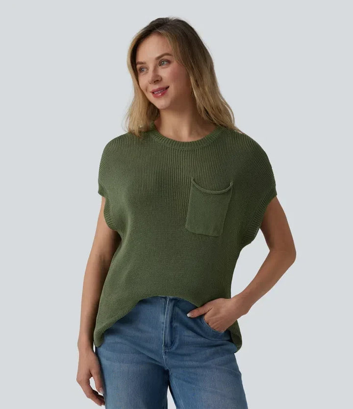Kvinna som bär grön kortärmad tröja med rund hals och ficka framifrån