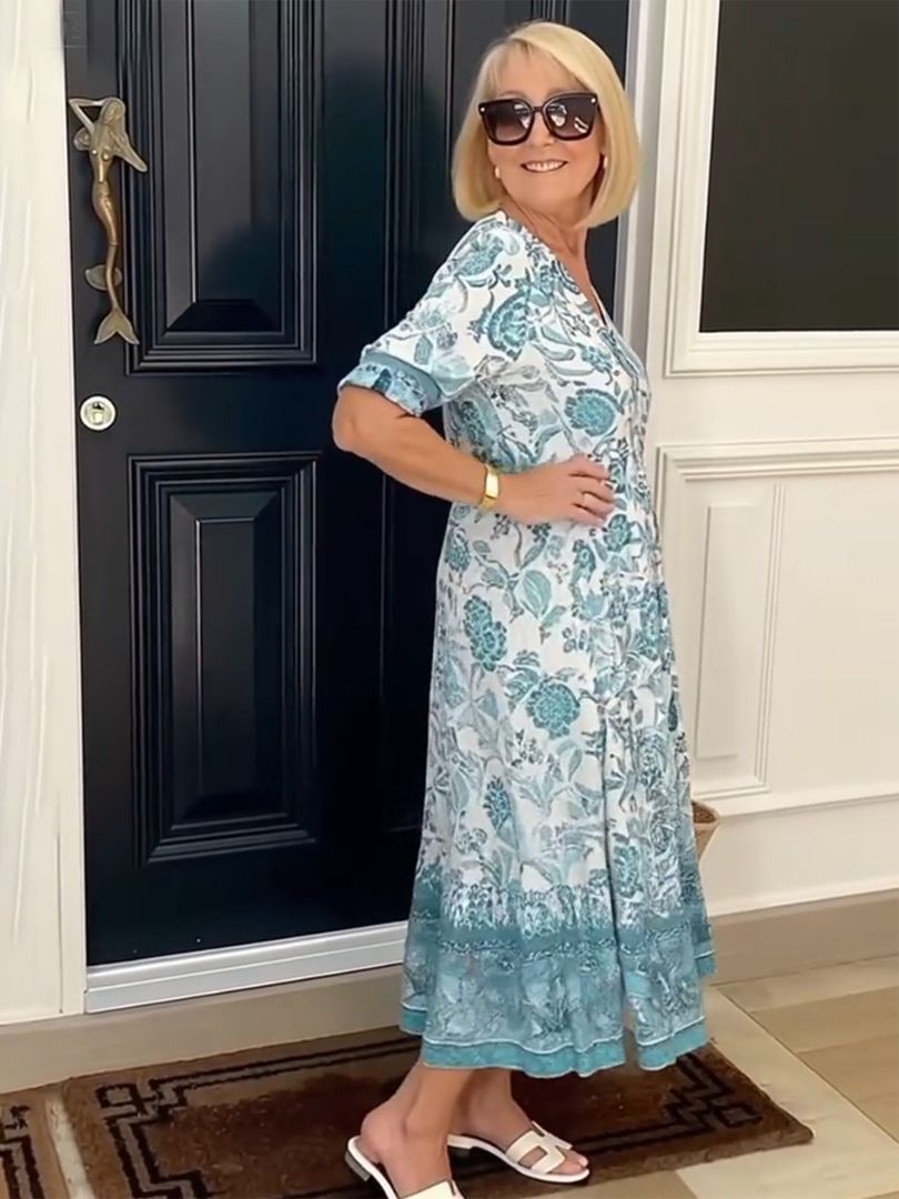 Snygg damklänning med blommor och V-ringning bakifrån