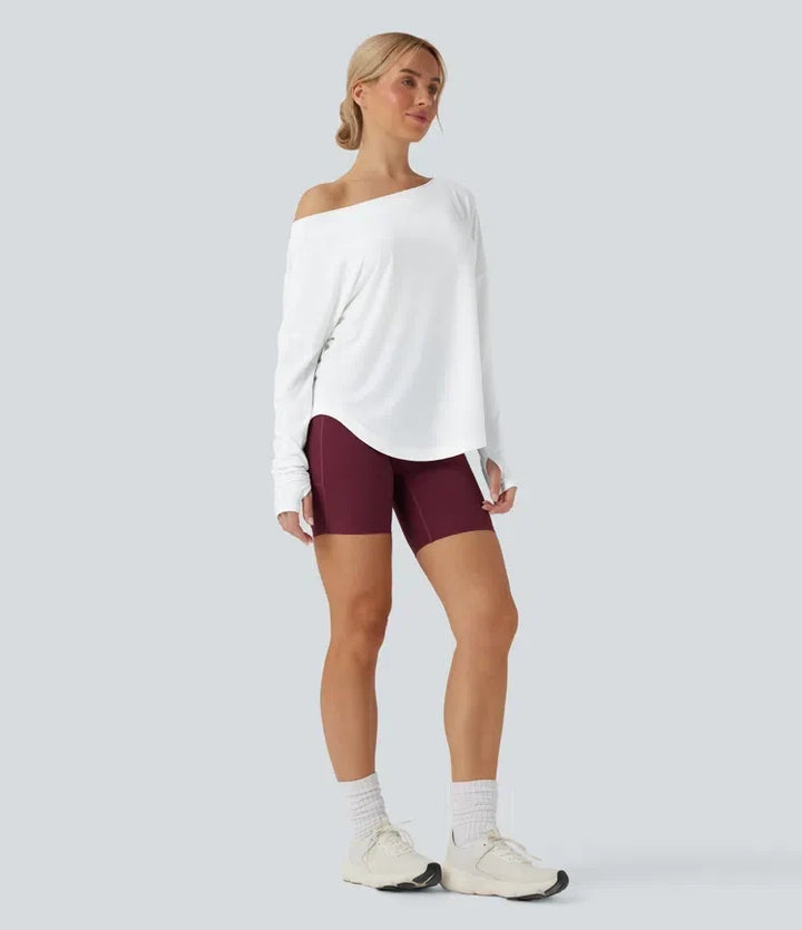 Yogasporttopp dam med detaljbild på det praktiska tumhålet