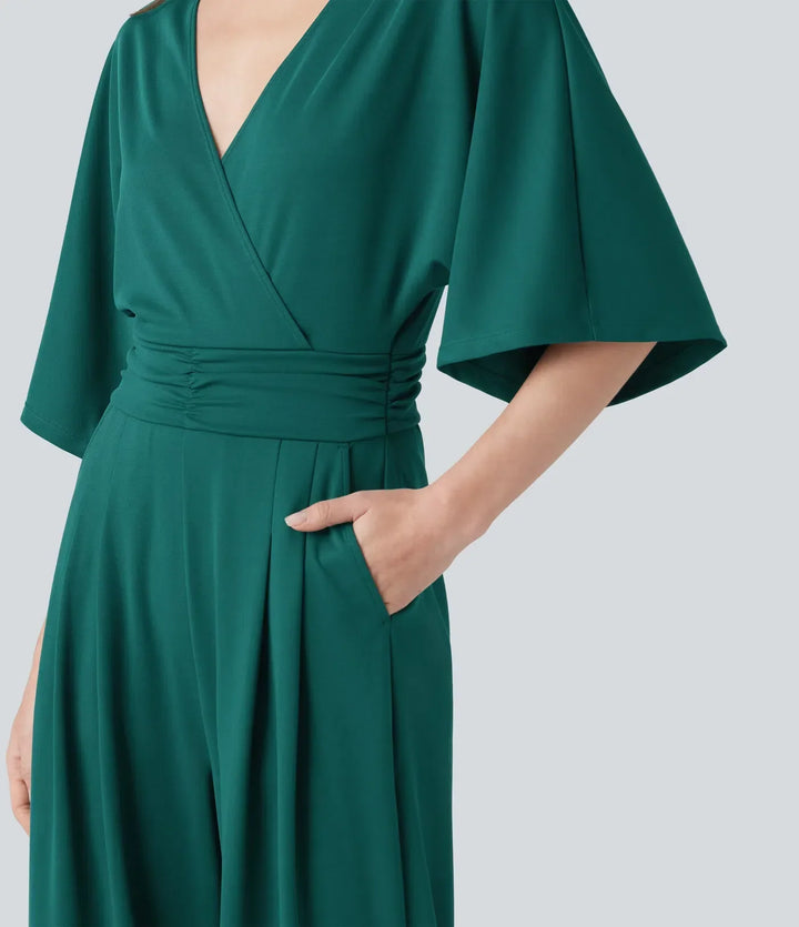 Snygg grön jumpsuit för dam med halvång ärm, visad från sidan