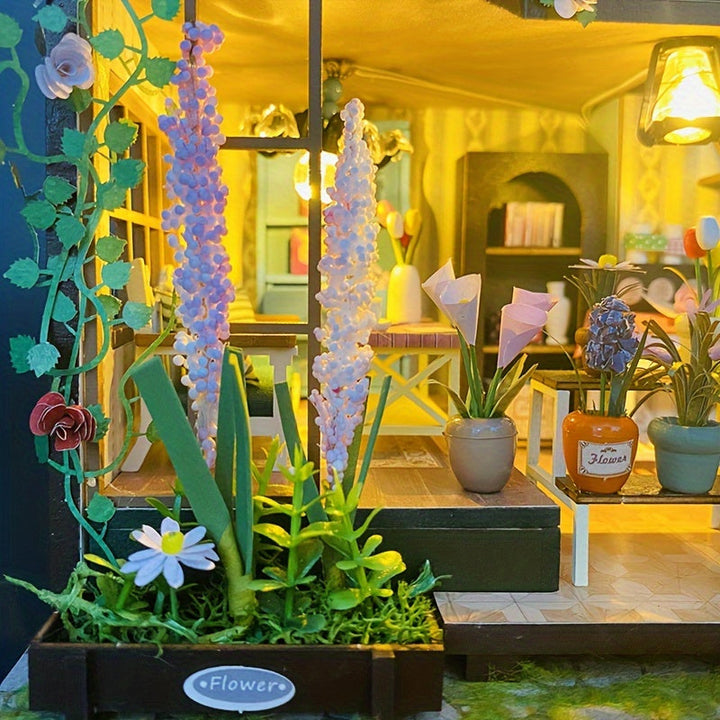 Detaljbild på blommor och krukor i handgjort miniatyrväxthus