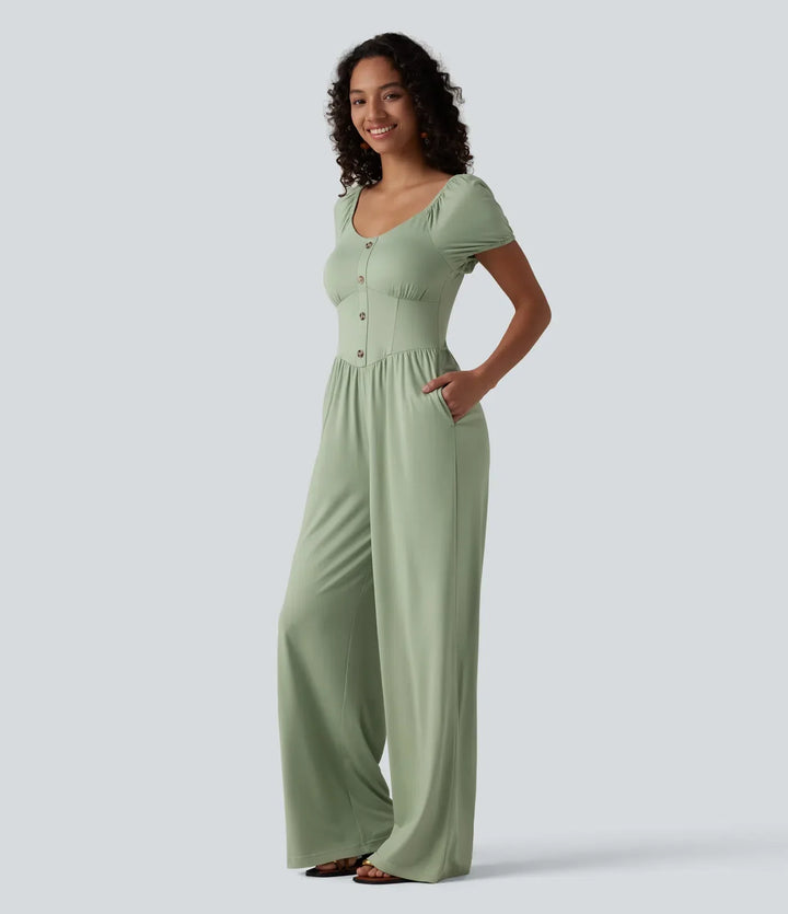 Sida av dam jumpsuit som visar praktiska fickor och korsettliv