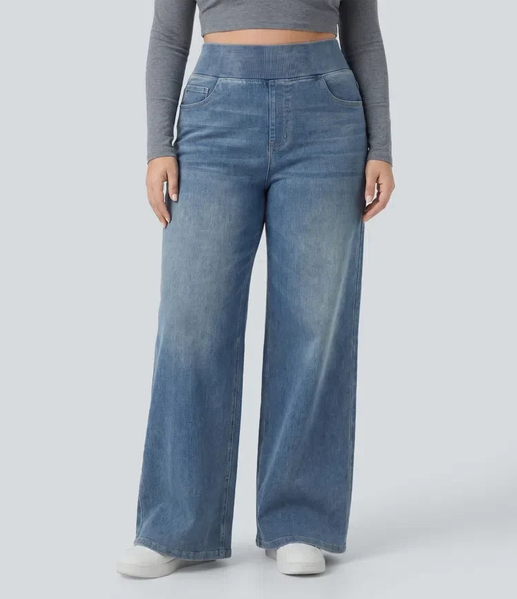 Framifrån av dam i högmidjade vida baggyjeans med tvättad finish