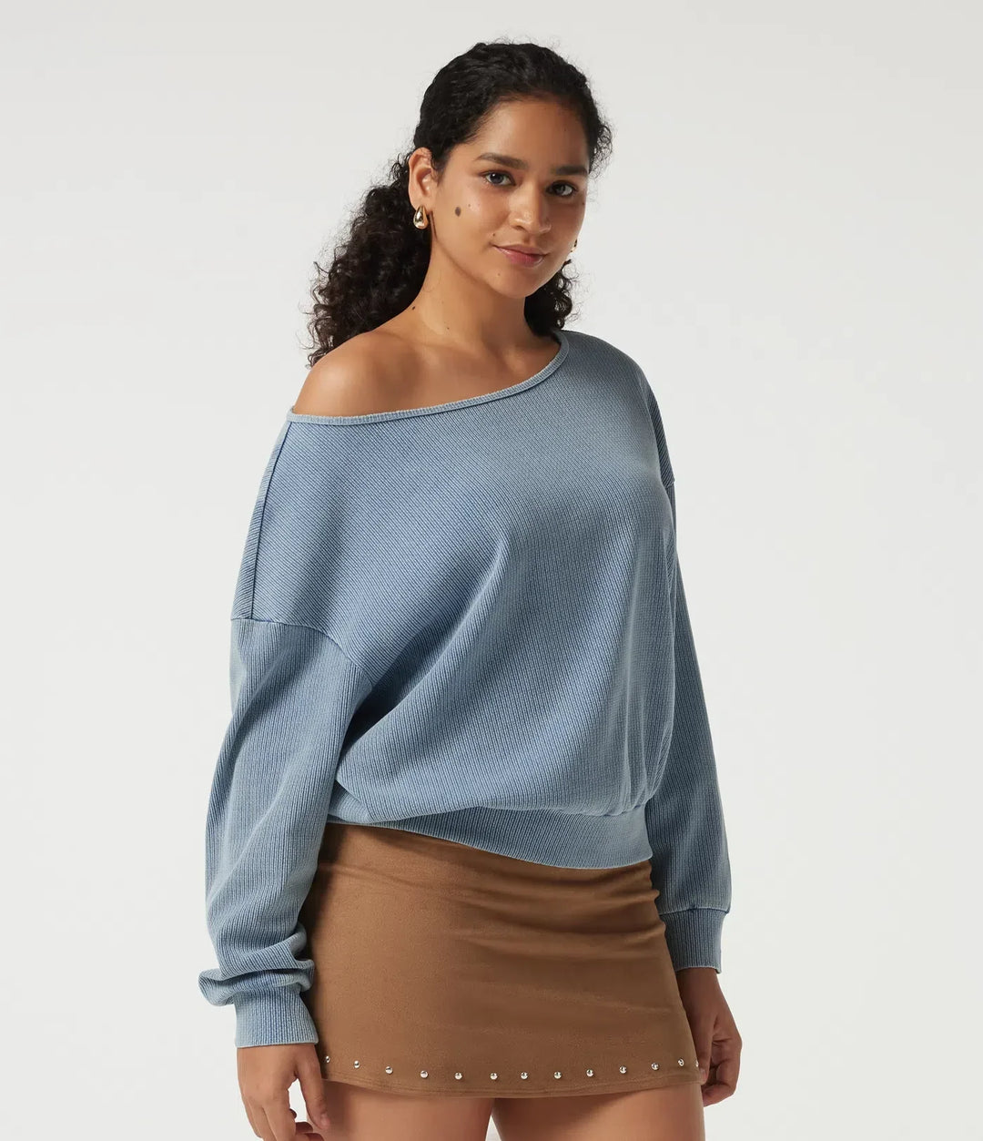 Närbild på modell i blå vardaglig sweatshirt med båtringning