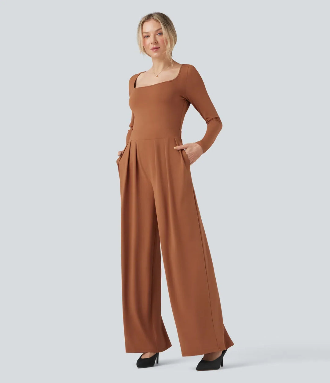 Brun jumpsuit med vida ben och fickor visad på modell