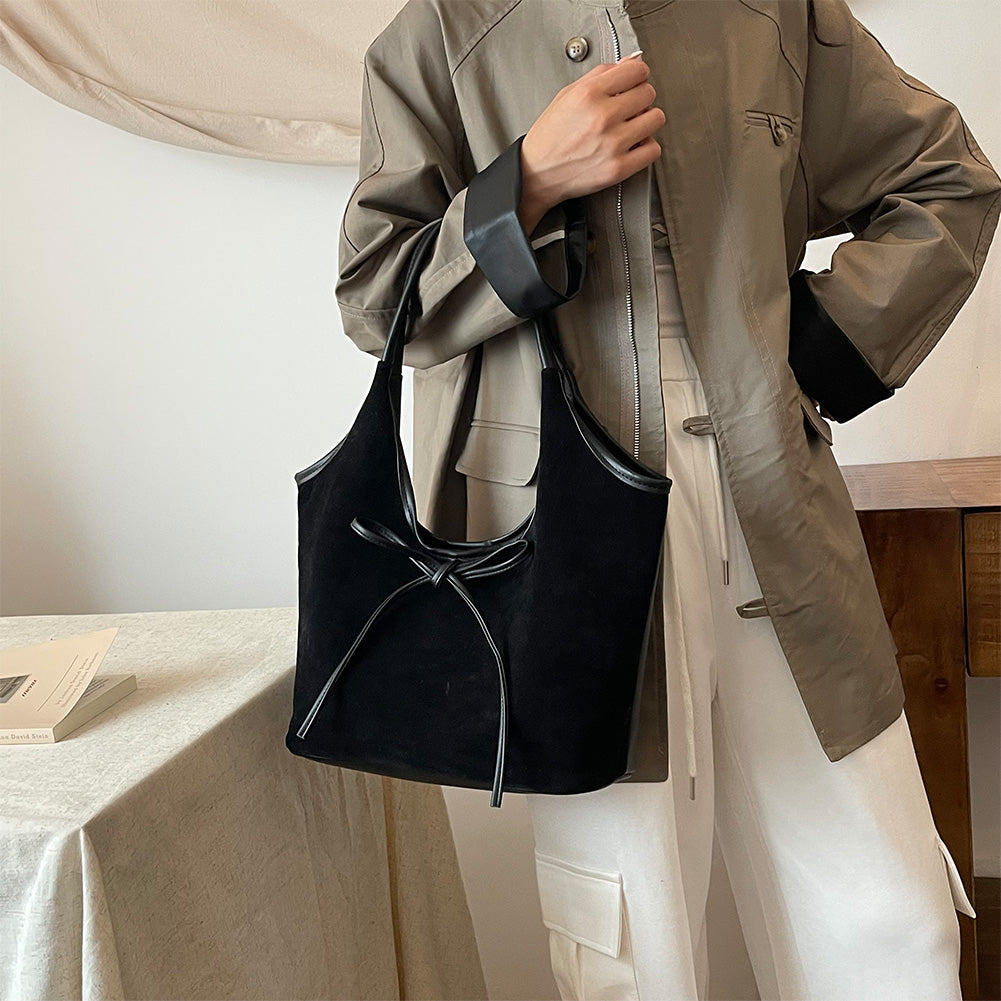 Närbild på rosettdetalj på elegant damväska