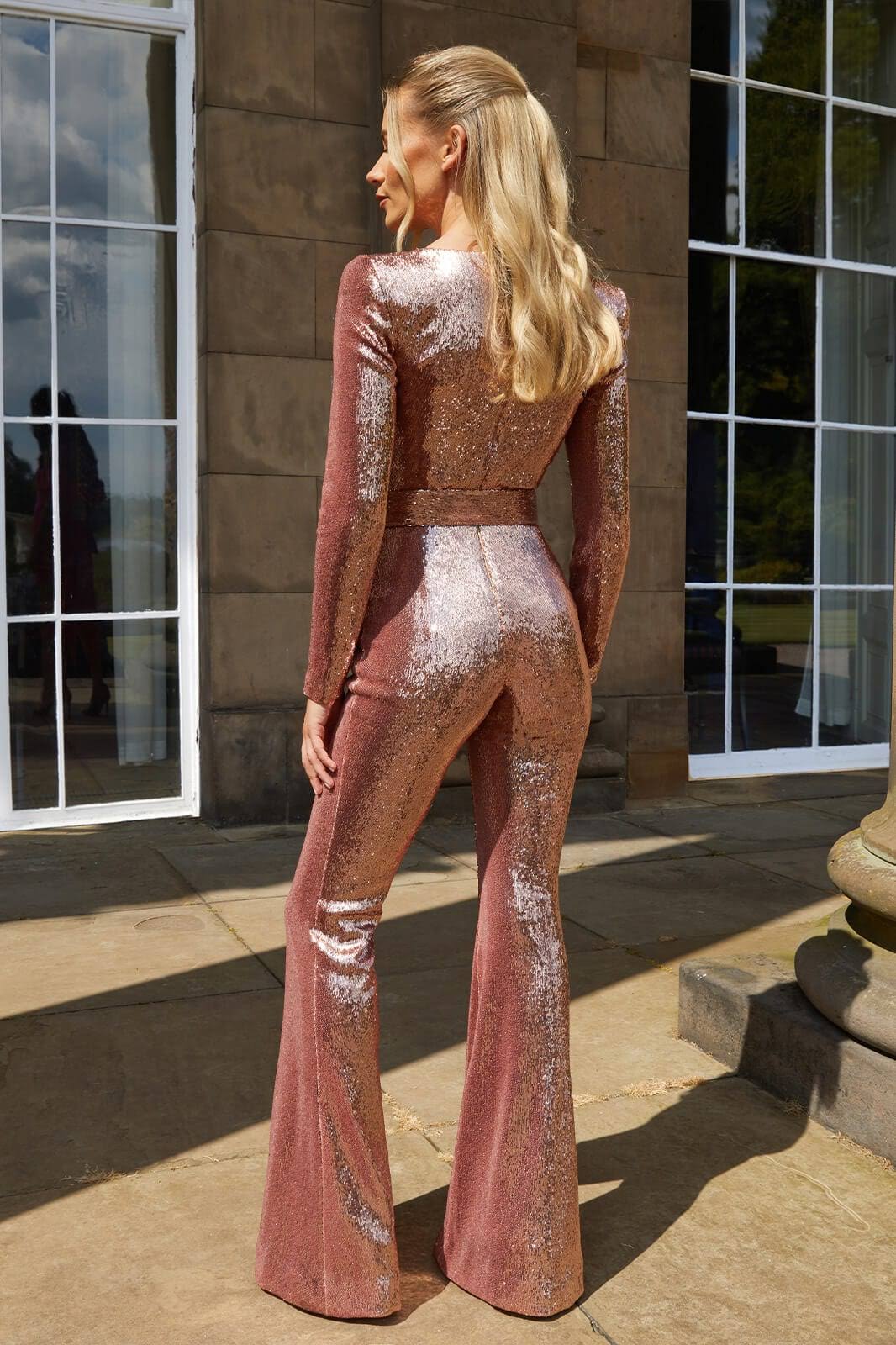 Baksida av elegant glittrig damjumpsuit
