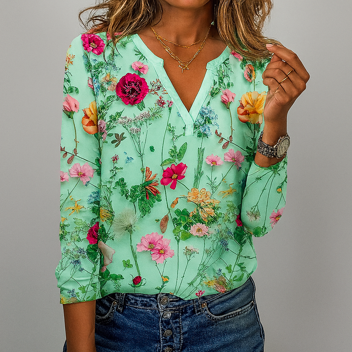 Kvinna i mintgrön blommig blus med detaljrikt mönster