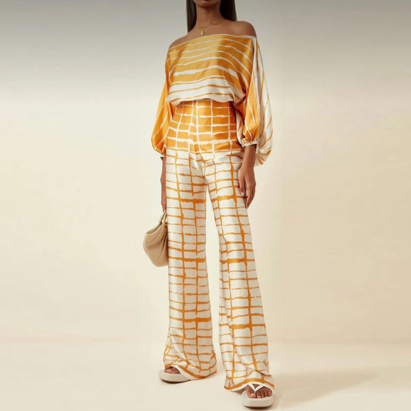 Stilrent dammode med off-shoulder design och långa vida byxor i ett co-ord set