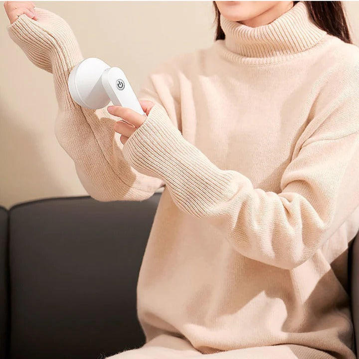 Ergonomisk luddtagare i vit design som tar bort noppor från tröjor