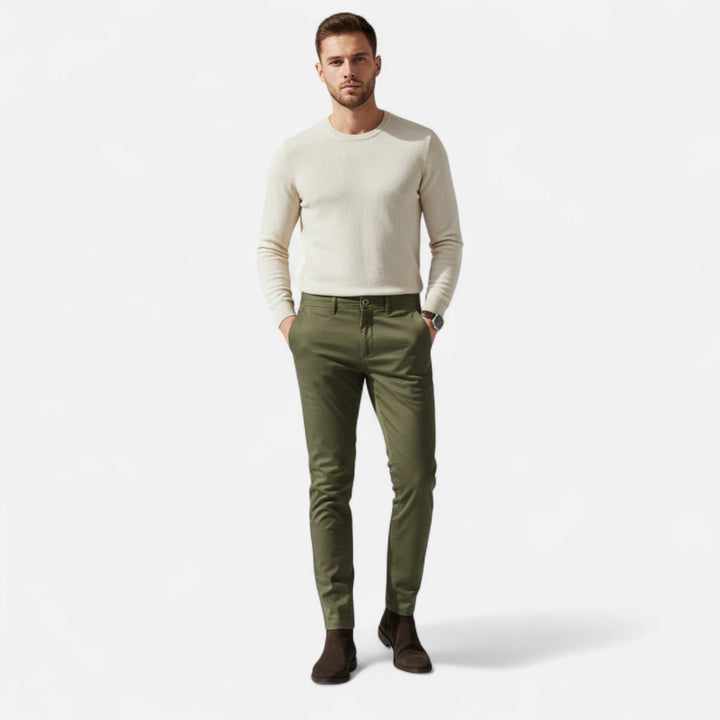 Manlig modell som bär gröna smart casual chinos med vit tröja