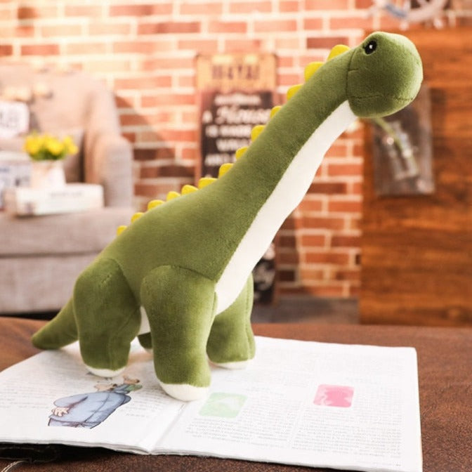 Grön dinosaurieplysch som står stadigt på underlaget