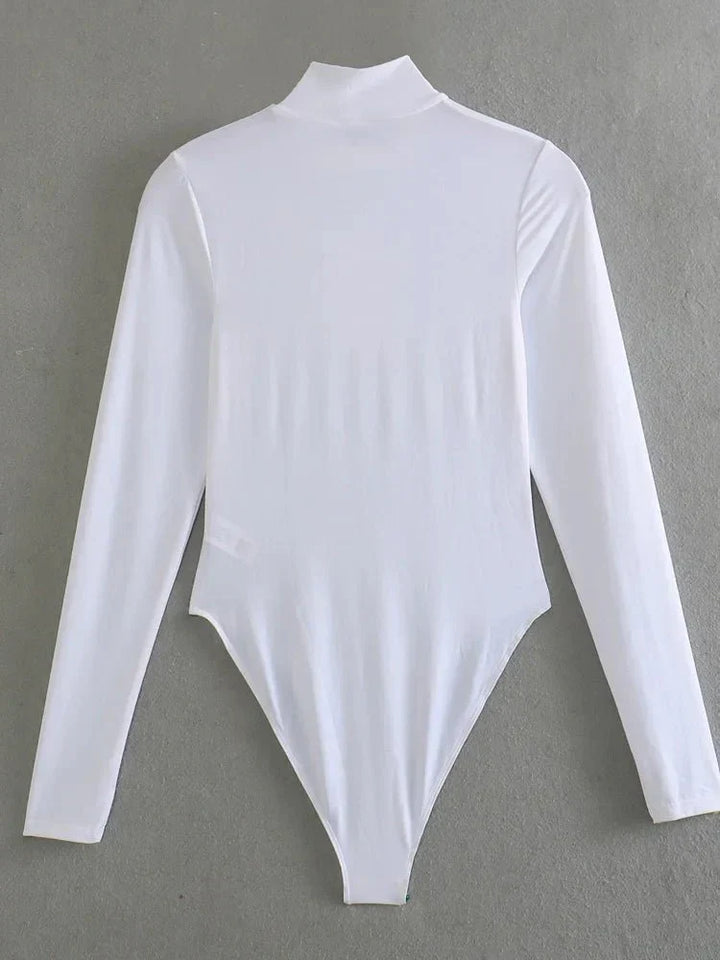 Baksida av vit långärmad bodysuit