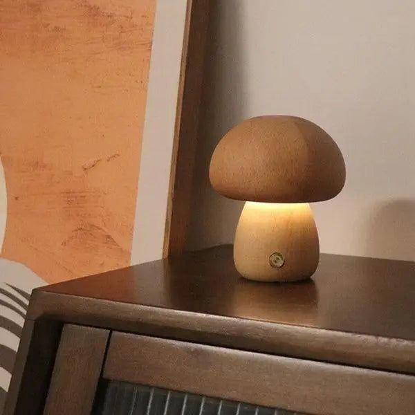 Dimbar USB-lampa i svampdesign placerad på ett modernt nattduksbord.