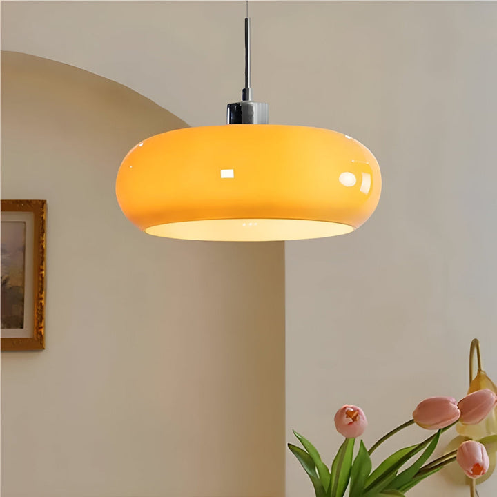 Clarity cirkelformad taklampa i orange glas med metallfäste i modern miljö