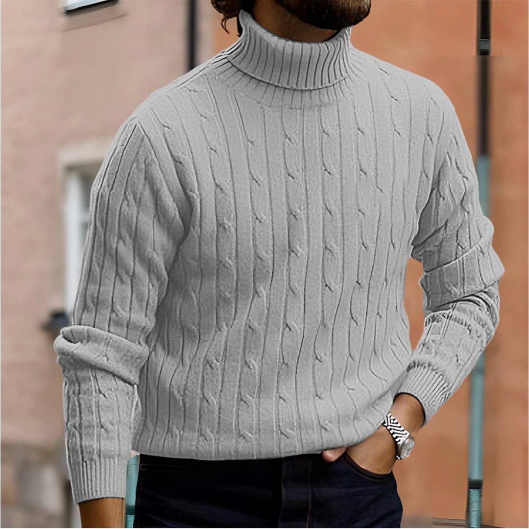 Närbild på det eleganta flätmönstret på en stickad herrtröja