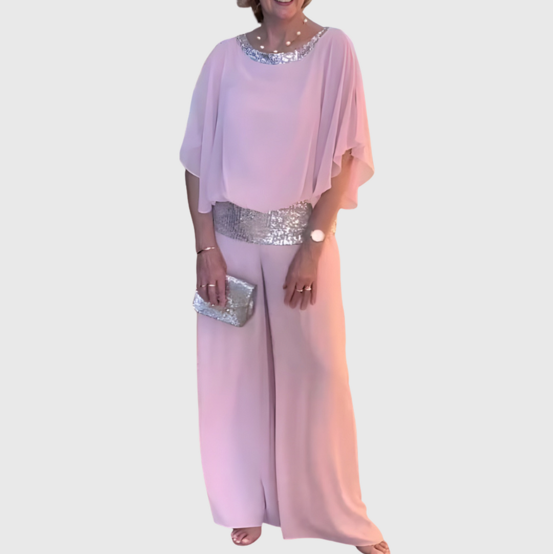 Kvinna i rosa elegant set med vida byxor och matchande accessoarer