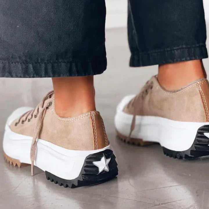 Baksidan av bruna plattformsneakers med vit stjärndetalj