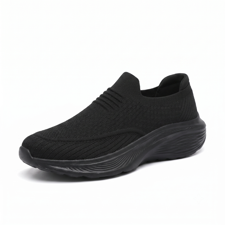 Svart unisex slip-on komfortsko med stötdämpande sula mot vit bakgrund