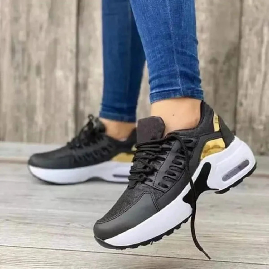 Svarta dam-sneakers med guldfärgade detaljer
