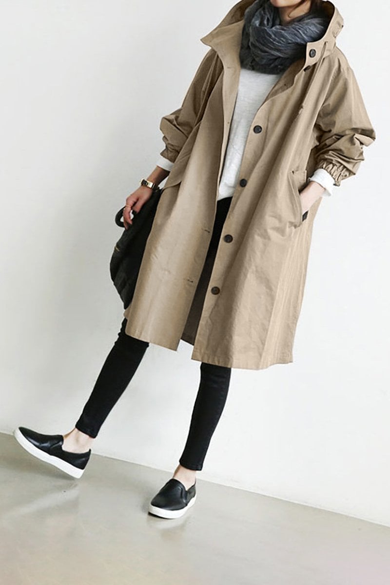 Mörk damjacka i trenchcoat-modell visad bakifrån med praktisk huva