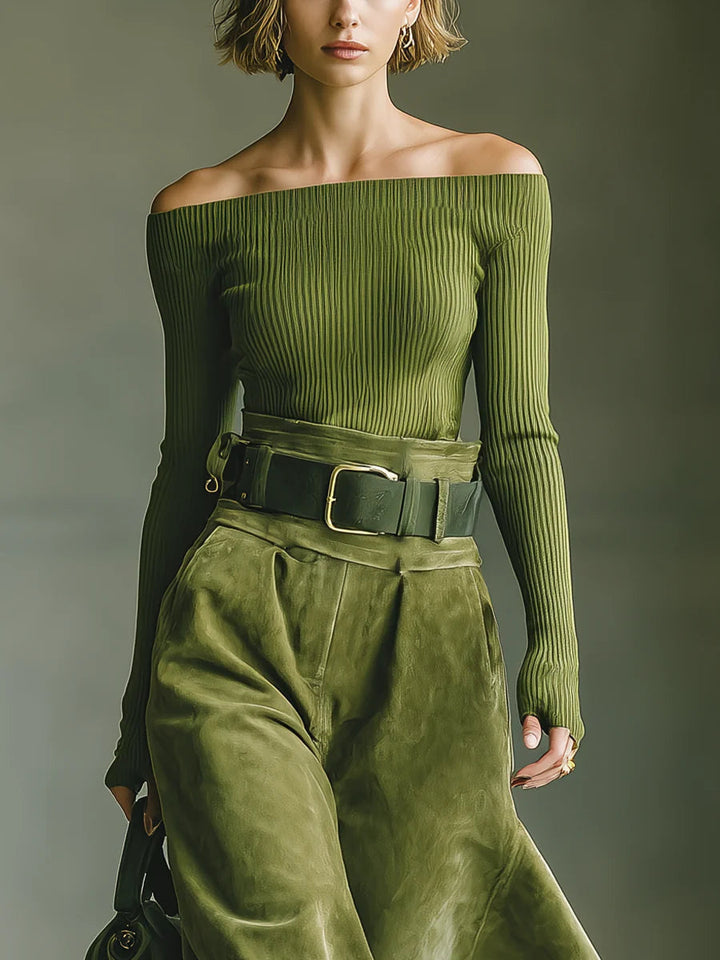 Närbild på den eleganta gröna off-shoulder-tröjan och midjebältet