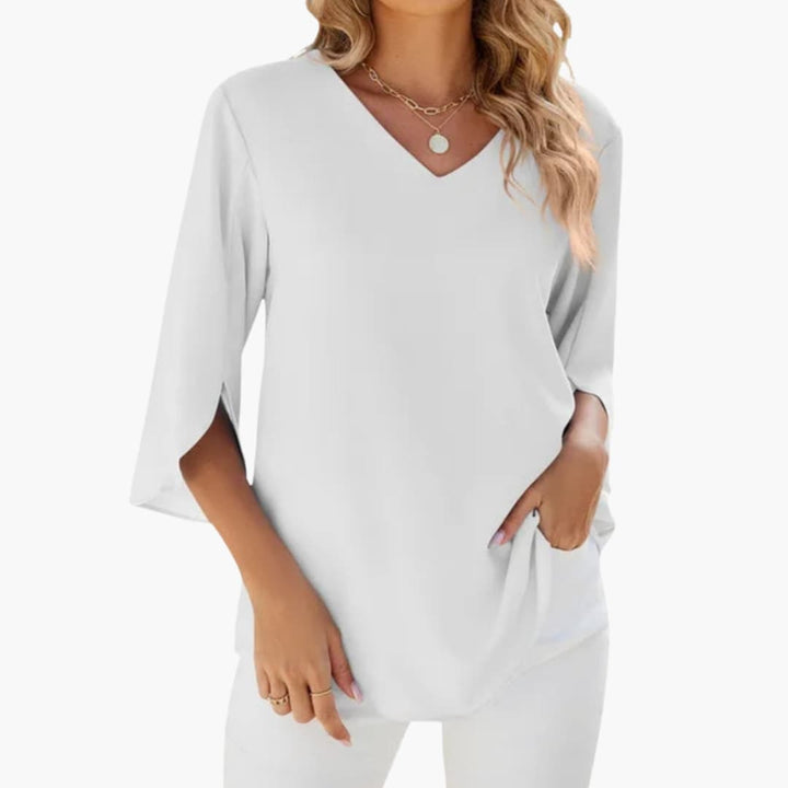 Vit elegant damblus med V-formad ringning och rak silhuett