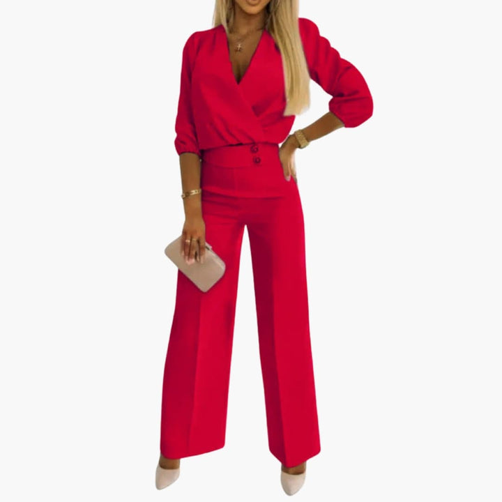 Elegant dam jumpsuit i svart med v-ringning och puffärm, perfekt som festklänning