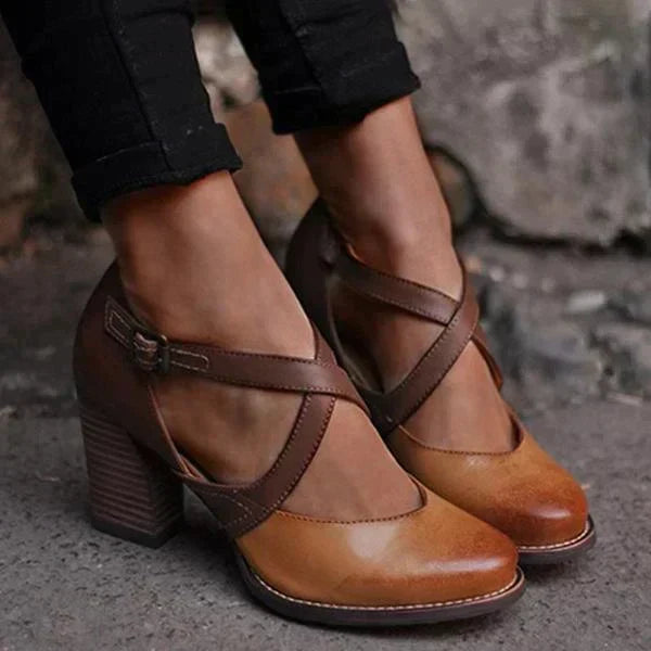 Närbild på dam Mary Jane-pumps med korsade remmar i brun cognac på fötterna