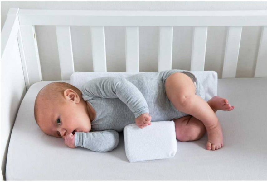 Ergonomisk antirullande babykudde som håller spädbarn säkert på sidan. Justerbar design i minnesskum.